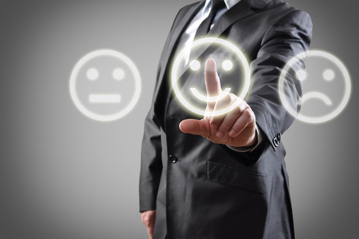 Businessman hand choosing smile on touch screen Businessman hand choosing smile on touch screen